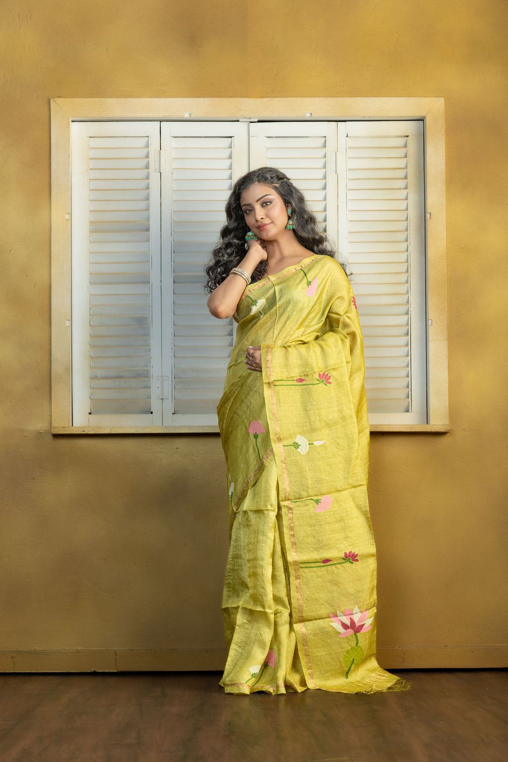 Hand Woven Bengal Tussar with needle work on pista colour base. A elegant vibrant festive drape with timeless craftsmanship.
