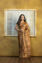Hand-woven Bengal Tussar with zari border on coffee colour base. A elegant vibrant festive drape with timeless craftsmanship.