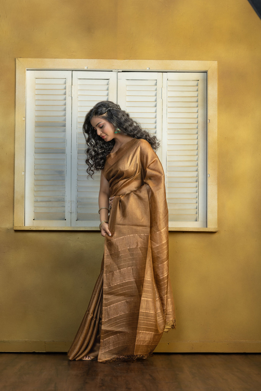 Hand-woven Bengal Tussar with zari border on coffee colour base. A elegant vibrant festive drape with timeless craftsmanship.