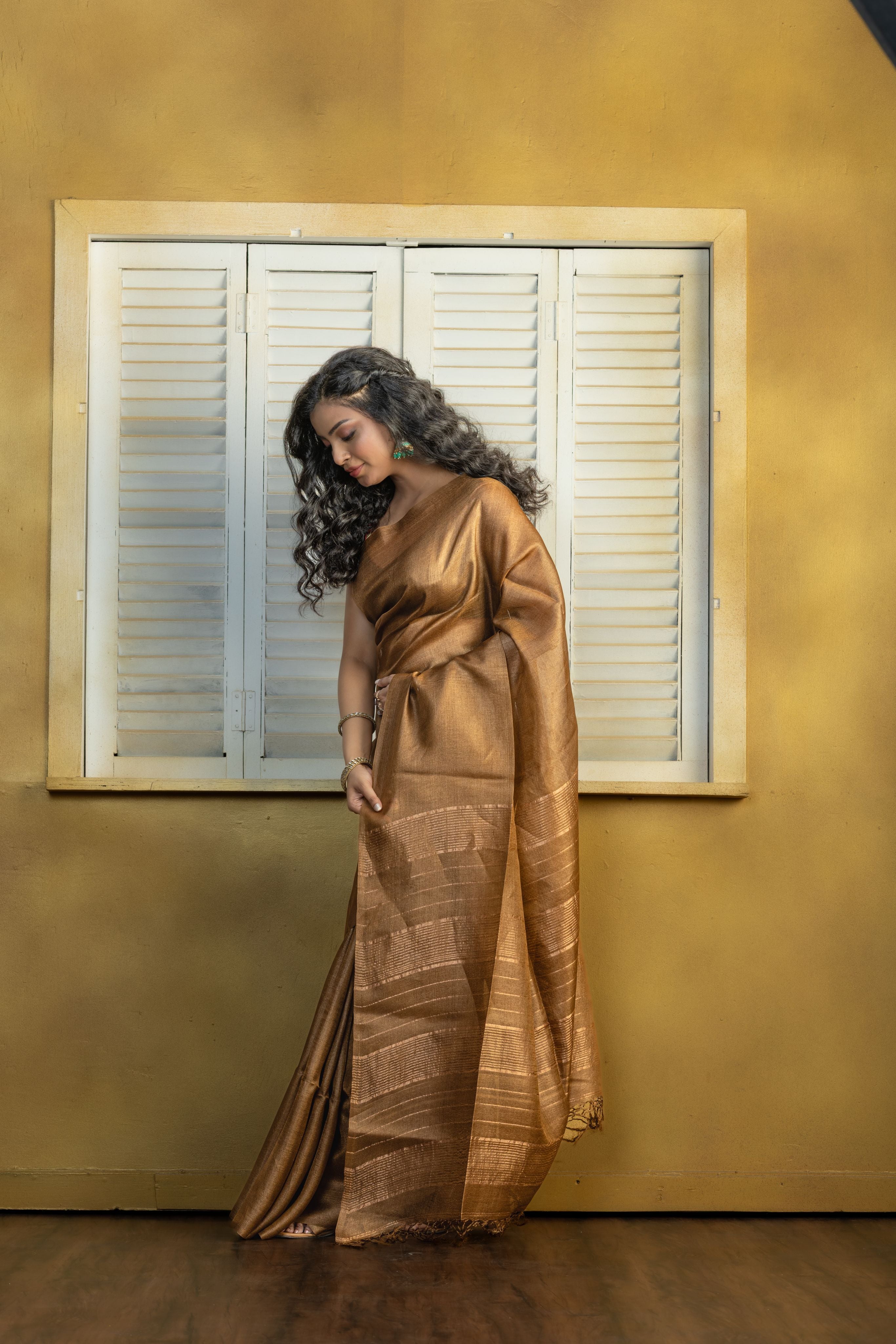 Hand-woven Bengal Tussar with zari border on coffee colour base. A elegant vibrant festive drape with timeless craftsmanship.