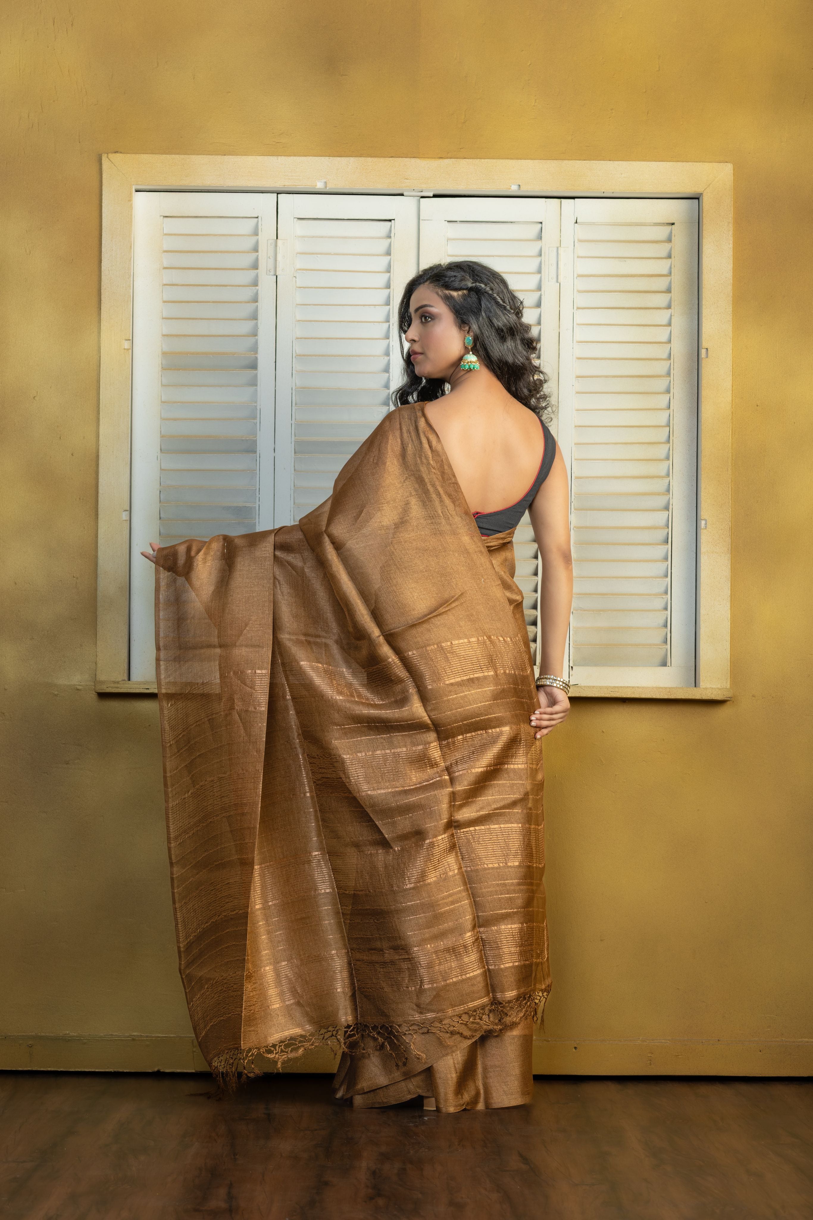 Hand-woven Bengal Tussar with zari border on coffee colour base. A elegant vibrant festive drape with timeless craftsmanship.