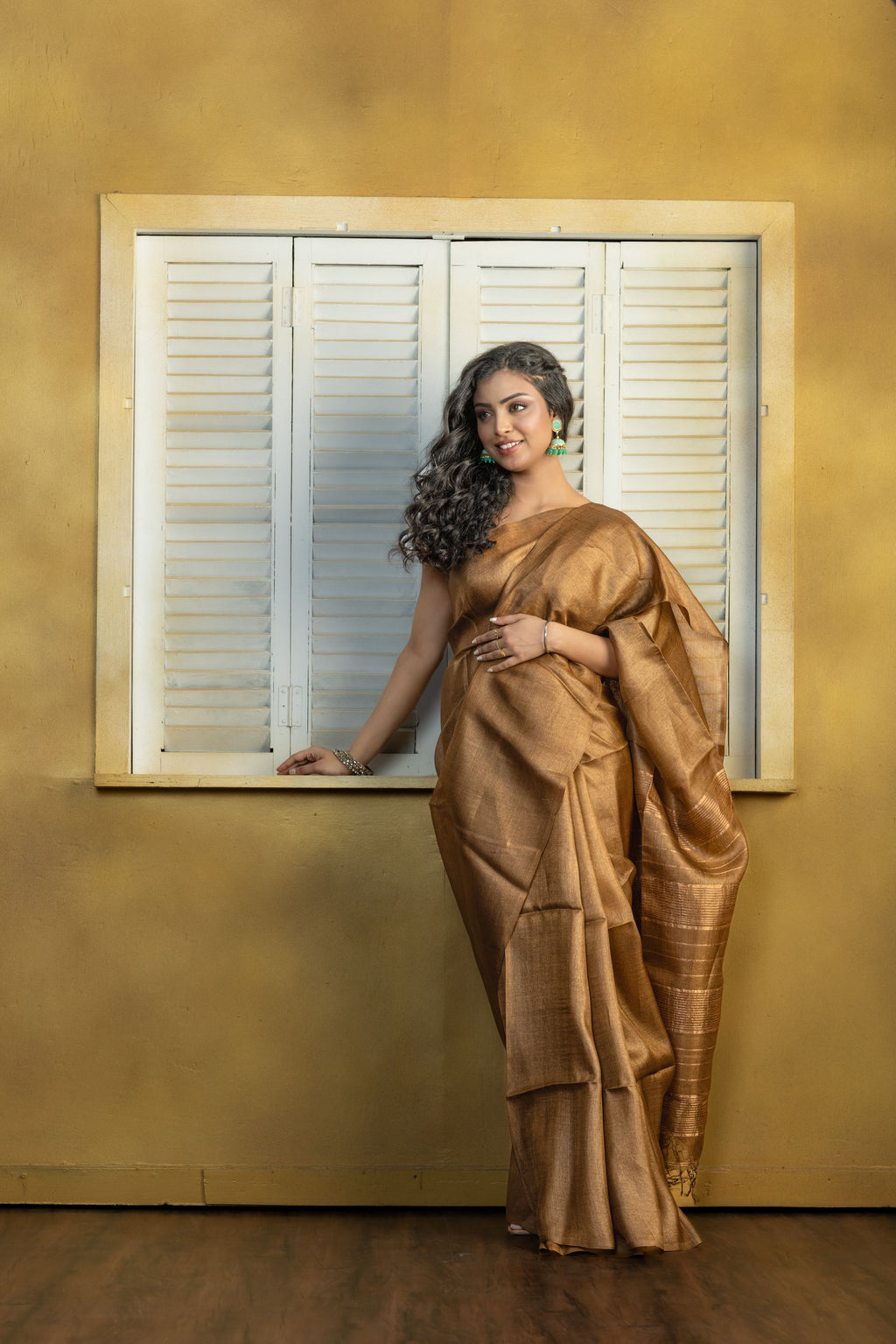Hand-woven Bengal Tussar with zari border on coffee colour base. A elegant vibrant festive drape with timeless craftsmanship.