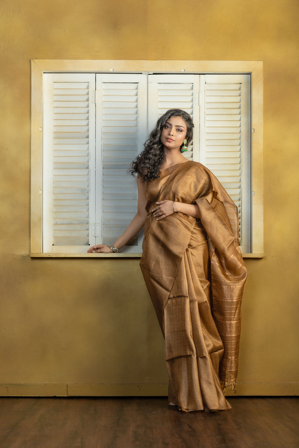 Hand-woven Bengal Tussar with zari border on coffee colour base. A elegant vibrant festive drape with timeless craftsmanship.