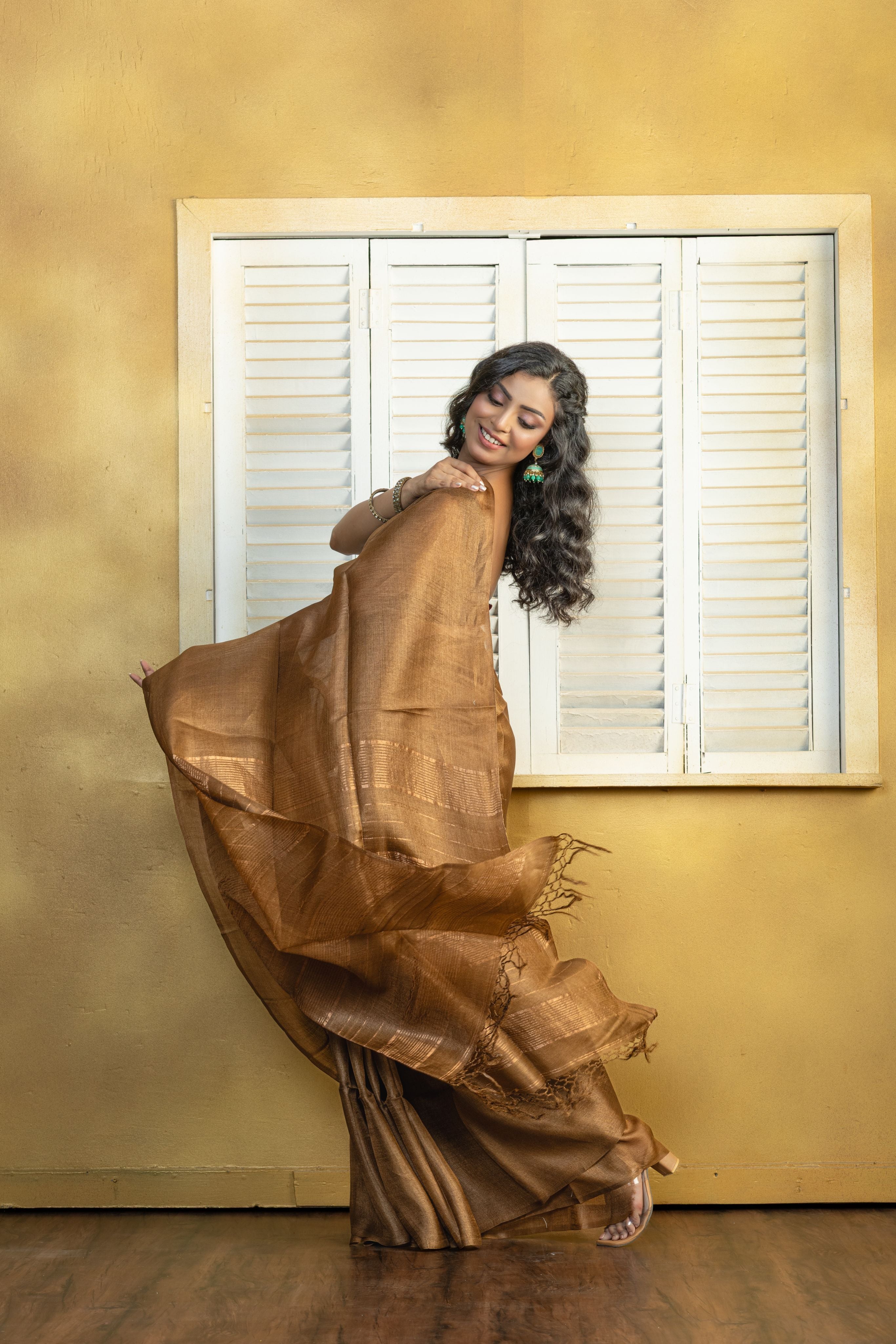 Hand-woven Bengal Tussar with zari border on coffee colour base. A elegant vibrant festive drape with timeless craftsmanship.