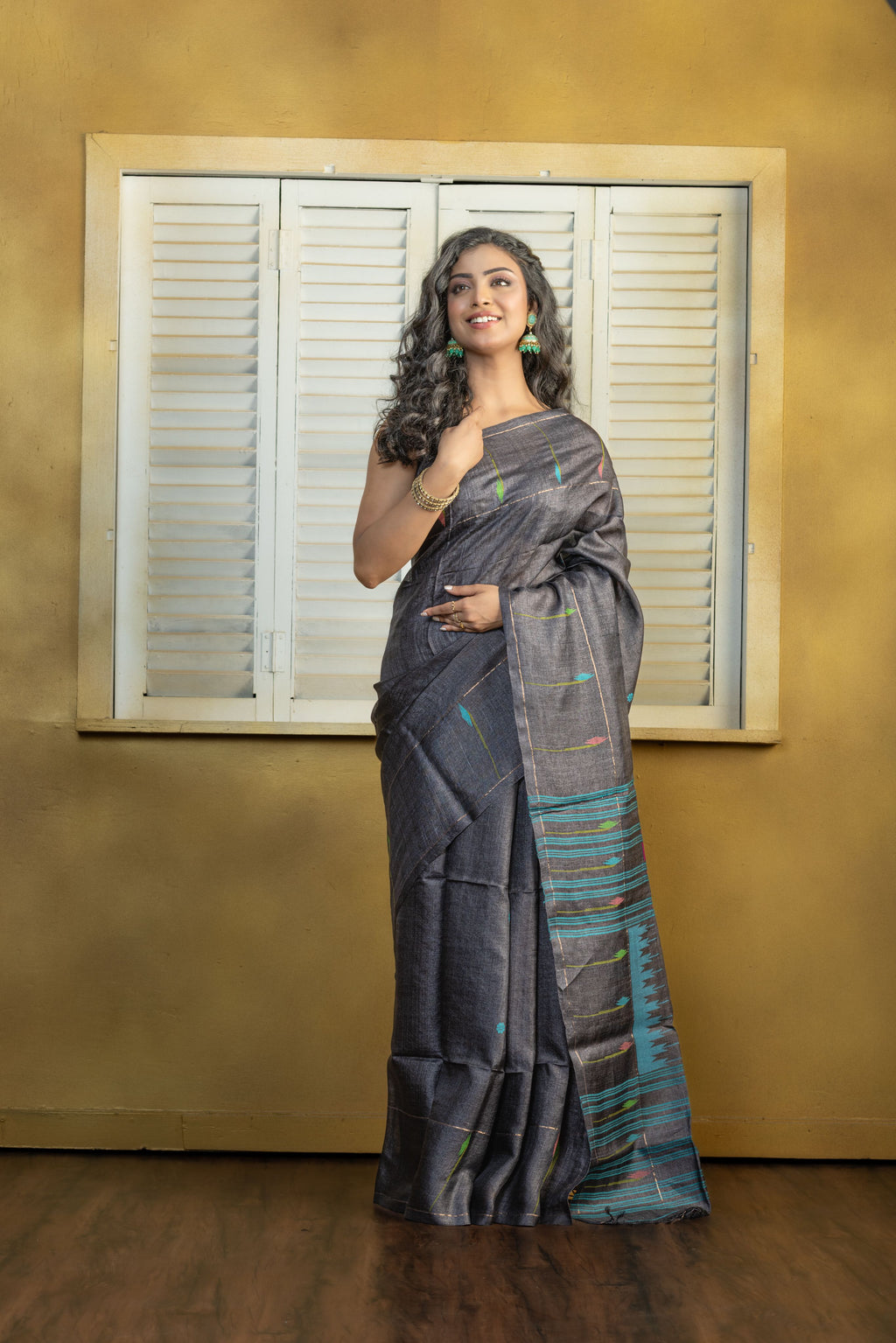 Hand-woven Bengal Tussar all over needle work Buta on black colour base. A elegant vibrant festive drape with timeless craftsmanship.